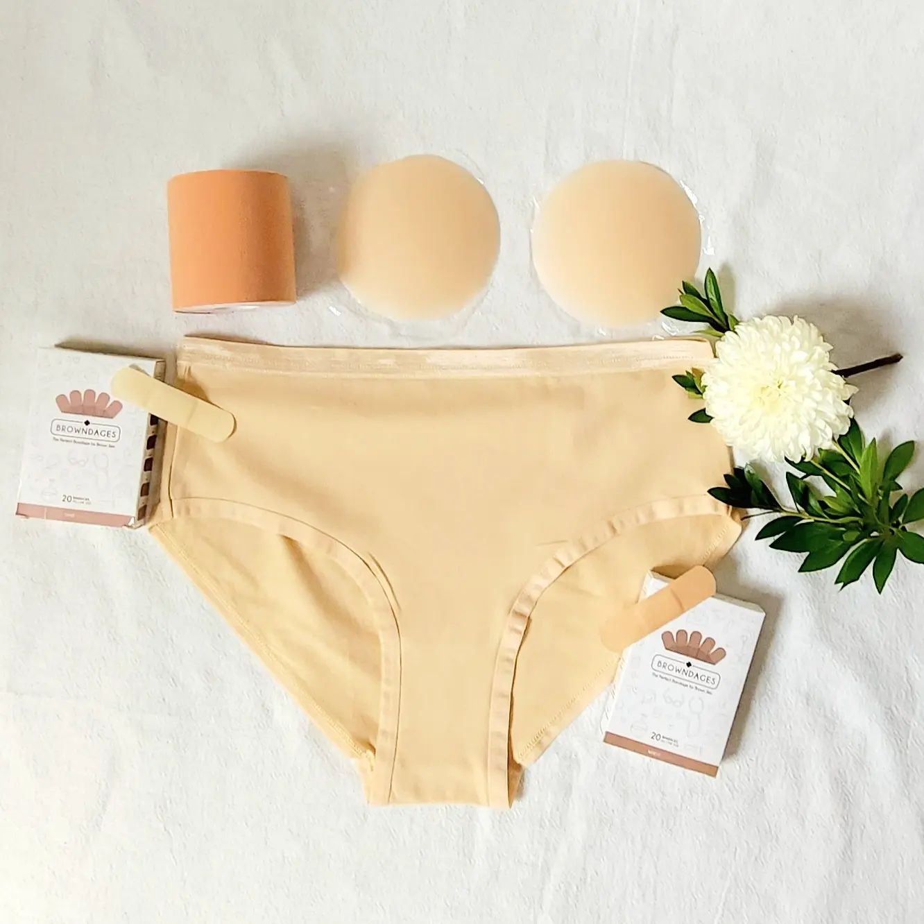 A bundle light beige panties, nipple covers, boob tape, and bandages.