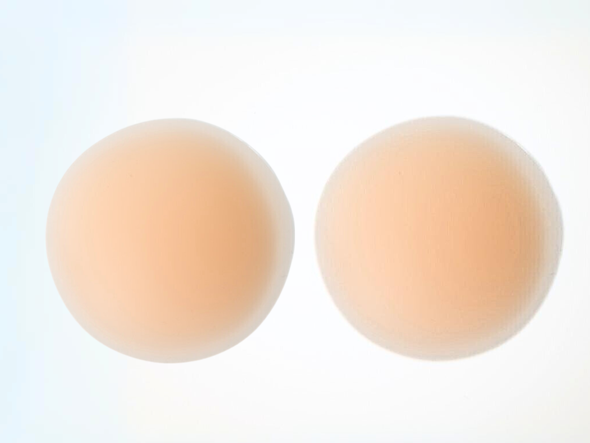 A pair of pinkish skin tone pasties for braless looks and hyperactive or sensitive nipples.