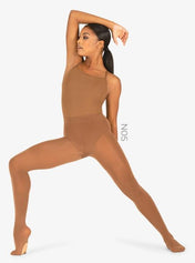 A Black woman is posing in nude color convertible tights for brown dancers and figure skaters.